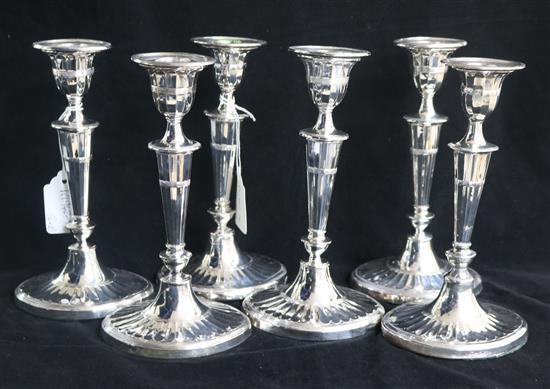 A pair of Victorian silver candlesticks, Sheffield, 1887 and a set of four silver plated candlesticks to match, 21.5cm.